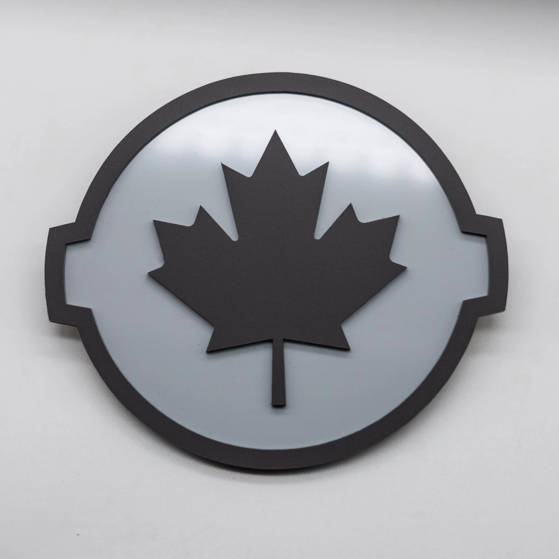 CANADIAN BADGE - FITS 2016-2024 NISSAN® TITAN® GRILLE - BLACK ON GREY