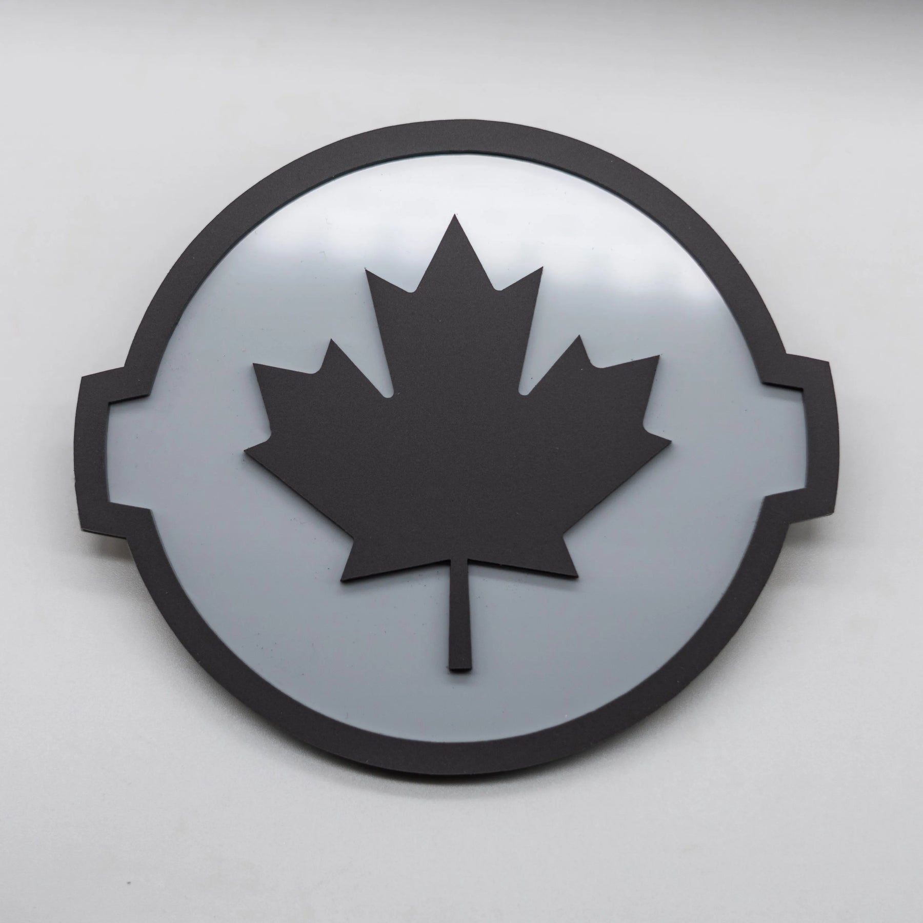 CANADIAN BADGE - FITS 2016-2024 NISSAN® TITAN® TAILGATE - BLACK ON GREY